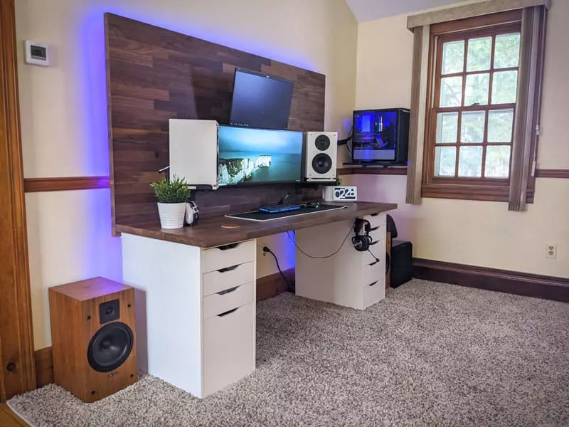 Rustic Desk Setup with Wall-Mounted Peripherals 